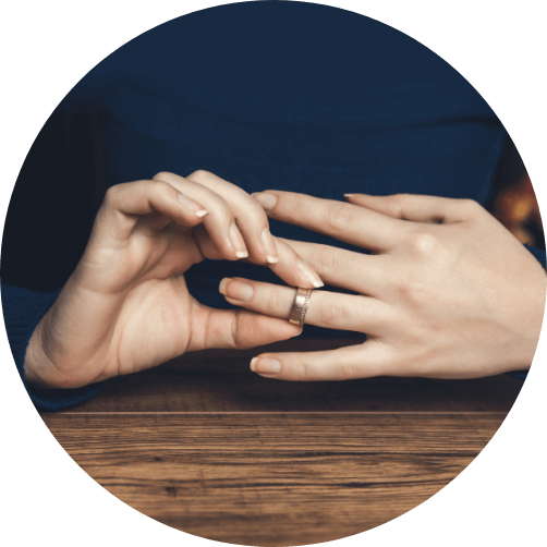 Woman's hand removing wedding ring