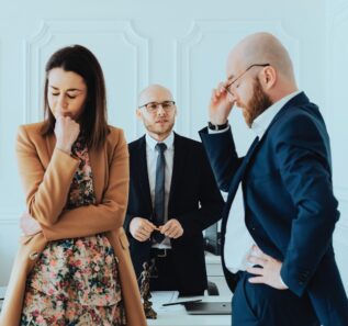 a frustrated couple with their divorce lawyer