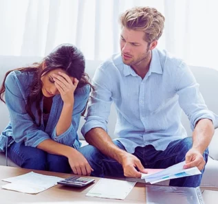 Worried couple doing their accounts in the living room. Financial Disclosure in an Uncontested Divorce