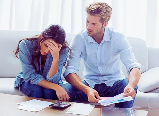 Worried couple doing their accounts in the living room. Financial Disclosure in an Uncontested Divorce