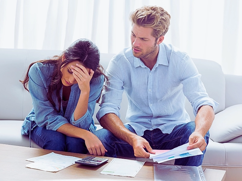 Worried couple doing their accounts in the living room. Financial Disclosure in an Uncontested Divorce