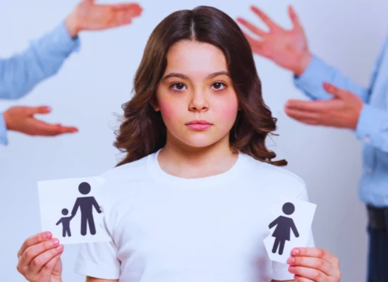 Sad young girl holding a broken piece of paper with family printed and arguing adults in the background. mandatory parenting class